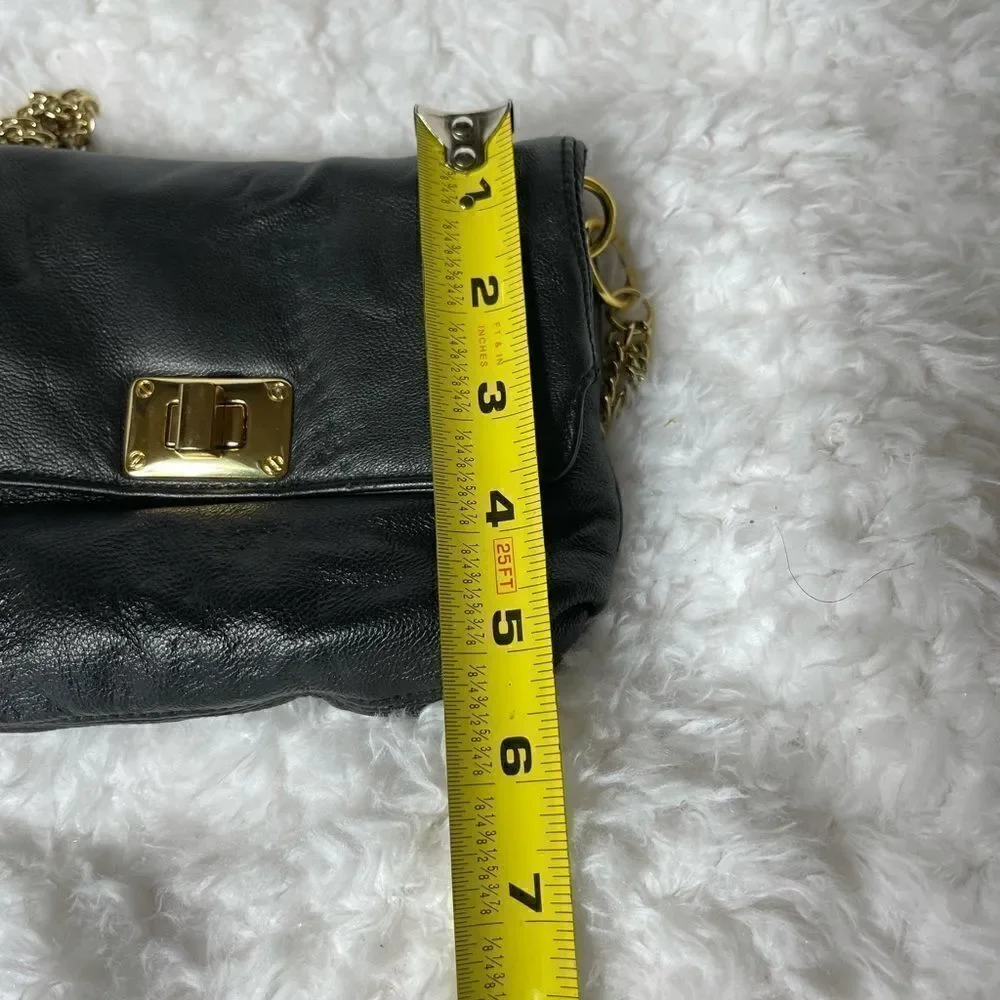 Paradox leather black small crossbody bag with ajustable gold tone chain.